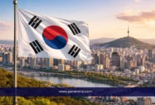 علم كوريا الجنوبية يرفرف فوق مدينة سيول مع إطلالة على نهر الهان وبرج نامسان – صورة لمقال منحة الحكومة الكورية GKS للبكالوريوس.