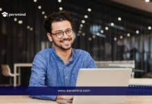 شاب يجلس أمام حاسوب محمول مبتسم، يمثل طالبًا أو باحثًا يقوم بإعداد أو استخدام نماذج خطاب توصية للمنح الدراسية والجامعات.