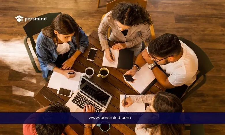 Group of students collaborating at a table while preparing their application for the Master Mind Scholarship in Belgium.
