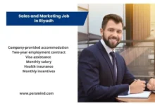 Business professional sitting at a modern office desk with an information panel highlighting benefits of a Sales and Marketing job in Riyadh.