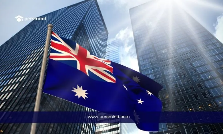 علم أستراليا يرفرف أمام ناطحات سحاب حديثة في مدينة أسترالية، يرمز إلى فرص الهجرة والعمل في أستراليا