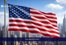 علم دولة أجنبية أمام أفق مدينة حديثة يرمز إلى دراسة الماجستير عن بعد في الخارج