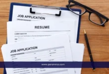 صورة لأوراق طلب توظيف وسيرة ذاتية على مكتب خشبي مع قلم ونظارات، تُستخدم في مقال فرصة عمل دولية في روسيا على موقع Persmind.