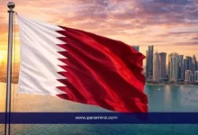 Qatar national flag waving over Doha skyline at sunset representing scholarship opportunities in Qatar