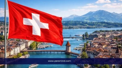 علم سويسرا يرفرف أمام بحيرة وجبال مدينة لوسيرن ضمن مقال عن برنامج قادة التجارة الشباب في جنيف