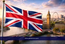 علم المملكة المتحدة يرفرف أمام نهر التايمز في لندن مع ظهور ساعة بيغ بن وعجلة لندن في الخلفية – صورة توضيحية لمقال قمة السلام في لندن.