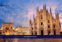 منظر مسائي لمعْلم معماري شهير في إيطاليا يظهر كاتدرائية تاريخية مضاءة في ساحة واسعة، ويُستخدم كصورة لمقال عن منحة جامعة سيينا الدولية للتميز