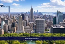 أفق مدينة نيويورك في الولايات المتحدة بصورة نهارية مع مبانٍ شاهقة وحديقة في المقدمة، تُستخدم كصورة لمقال عن منحة نايت هينيسي في جامعة ستانفورد