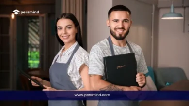 Restaurant staff smiling in a hospitality setting for an article about recruitment in Saudi Arabia, highlighting job opportunities in the service and hotel industry.
